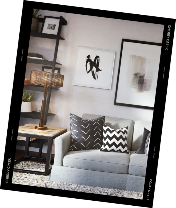 Living room with plush couch, decorative pillows, and framed artwork.